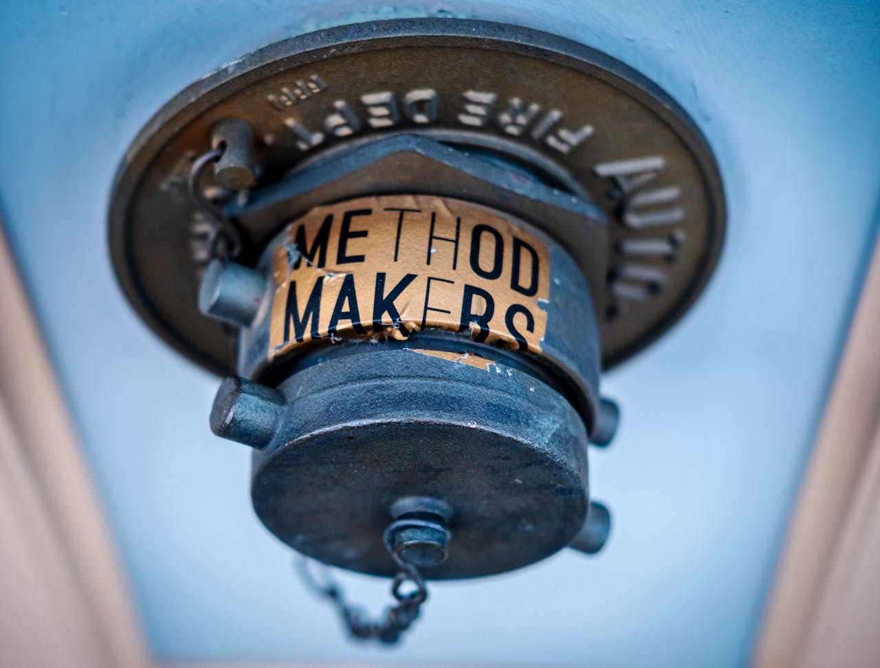 Blue vintage fire sprinkler head with metallic texture and Method Makers label.